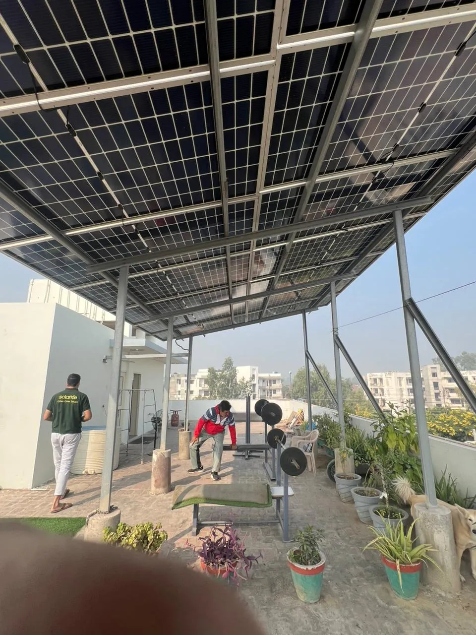 Existing rooftop solar canopy with steel supports and usable terrace space beneath
