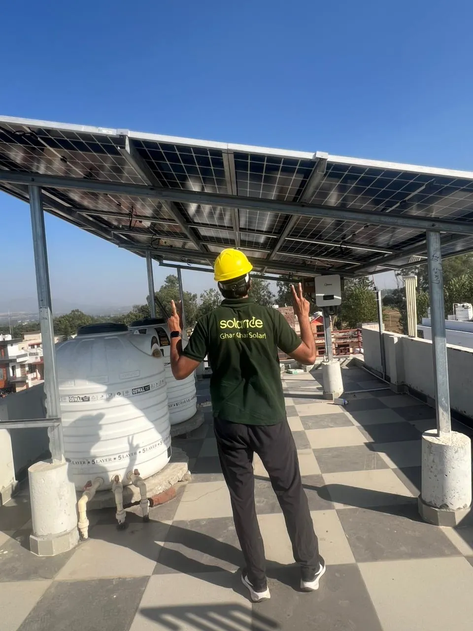 Solaride crew member beneath installed rooftop solar panels